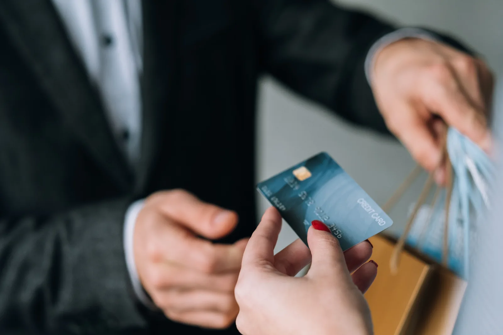 Customer paying by card at store checkout, representing supplier payment and mass disbursement flows.